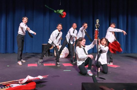 4th Graders throw roses into the adoring crowd during their performance for the Upper School on March 4 (Photo/PDS Flickr)